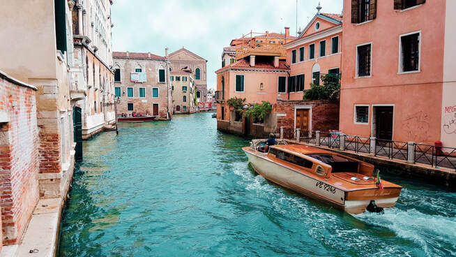 Italy's Golden visa program | Elegant boat running through Venice's channels